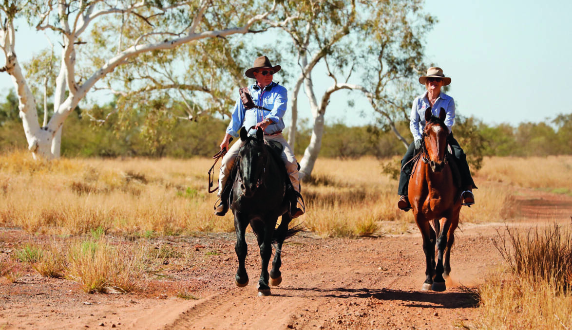 TWIGGY: Andrew Forrest and wife Nicola riding through one of their sprawling properties. Photo by Hugh Brown. 
