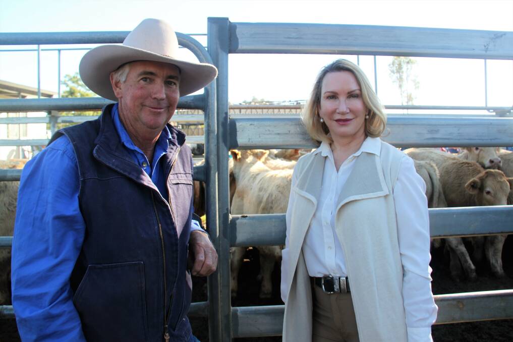  Lyndhurst manager Russell Fogg with property owner Catherine Gaulton, Brisbane. The 16 weaners were awarded champion pen of steers and sold for $1070/head to Taroom producer David Brennan.