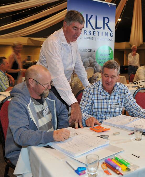 Rod Knight discusses the finer points of livestock marketing with producers at a recent school.
