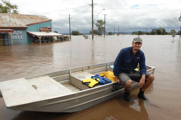 David Cameron, Department of Natural Resources and Mines, surveys the flood damage on the corner of the Warrego Highway and Tallegalla Road, Marburg. Picture: RODNEY GREEN.
