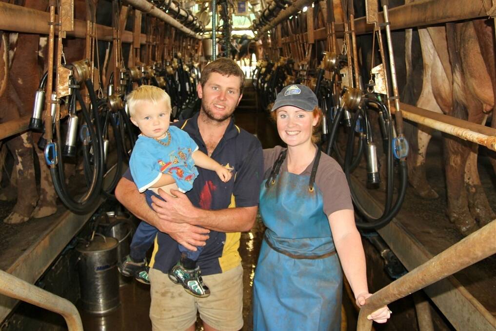 Siblings James Johnston and Kasey Clark with James' one-year-old son Jeshua, at the family's Malanda dairy.