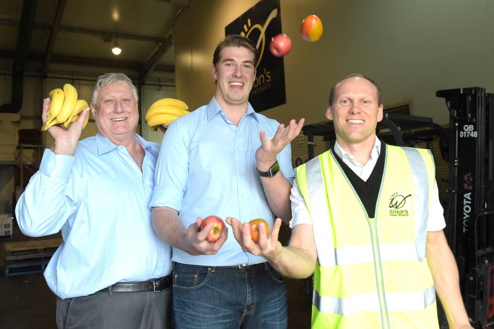 Bob Wilson and son Adam, Wilson’s Fresh Produce, and John-Paul Drake, Drakes Supa IGA, Adelaide, celebrate the launch of It’s Fresh Queensland. – Picture: RODNEY GREEN.