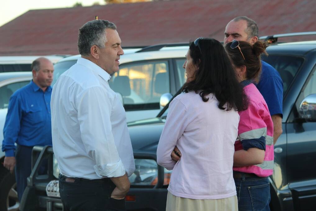 Federal Treasurer, Joe Hockey, spoke to Brittany Stuart, 21, and her parents Cate and Mark Stuart, in the car park of the Charleville racecourse after meeting with drought affected landholders last Thursday.