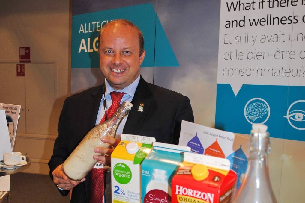 Alltech's algae expert Csaba Kenez with a bottle of dried algae produced in heterotrophic conditions and a range of milk products containing DHA.