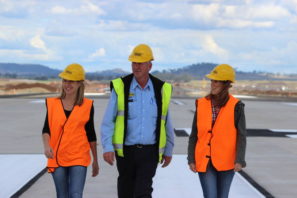 Denis Wagner, one of the directors of the Brisbane West Wellcamp Airport looks over the completed runway with his media team, Lyndal Dennis (left) and Karen McKinley. Picture: BRAD COOPER