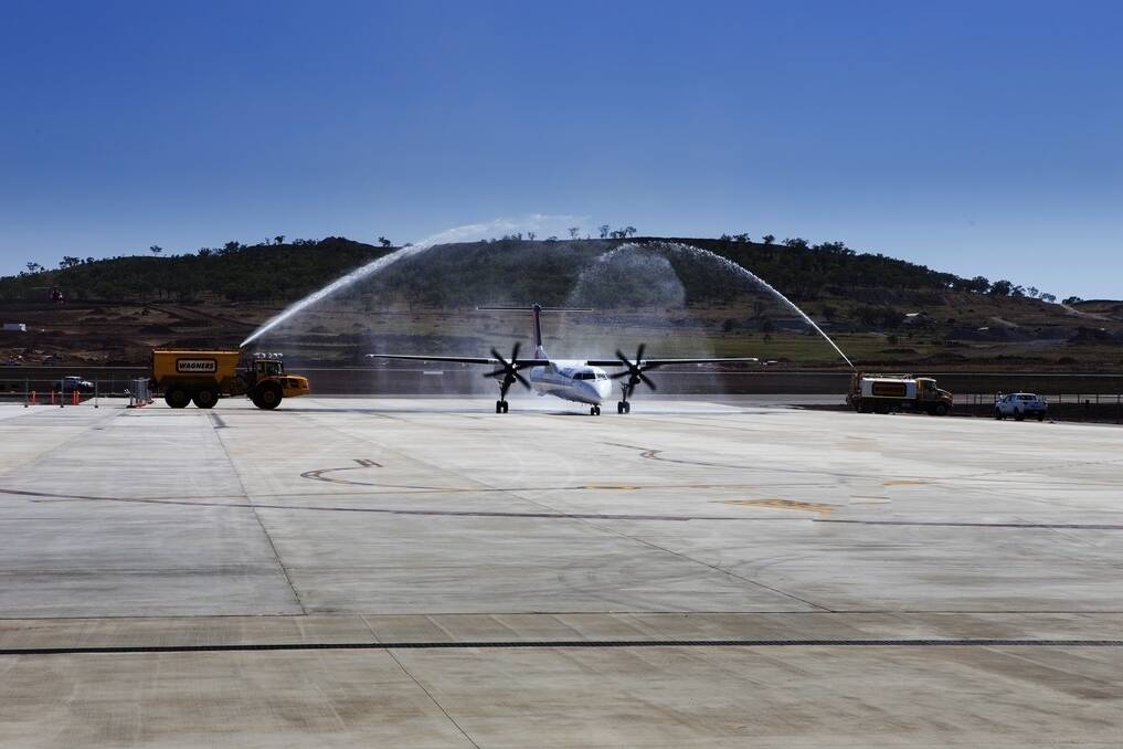 The inaugural Qantaslink flight is given a showery welcome to the new Brisbane West Wellcamp Airport.