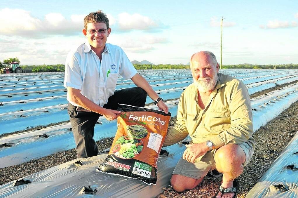 Barmac territory manager Renier Scheepers and Merv Schiffke of the Taste 'n See strawberry-growing enterprises near Caboolture on Queensland's Sunshine Coast, with one of the custom Ferticote, eight-month controlled release blends they now use for their base plant nutrition.