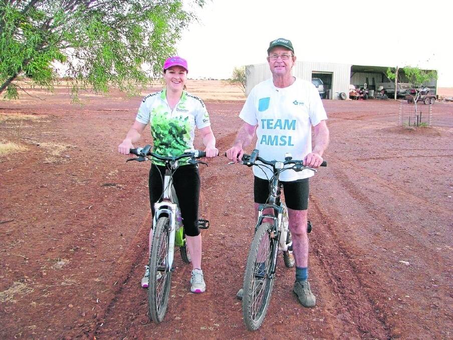 Longtime diabetic Emma Hegarty getting ready for a training ride at Colanya, Longreach with her father Pat Hegarty. The pair are taking part in the Dirt N Dust triathlon at Julia Creek in April to raise money and awareness of diabetes.