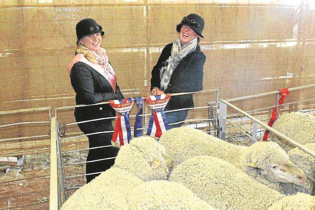 Flock sheep steward Allycia Bennett and winner of the champion pen of ewes, Terry Rosenow from Powella.