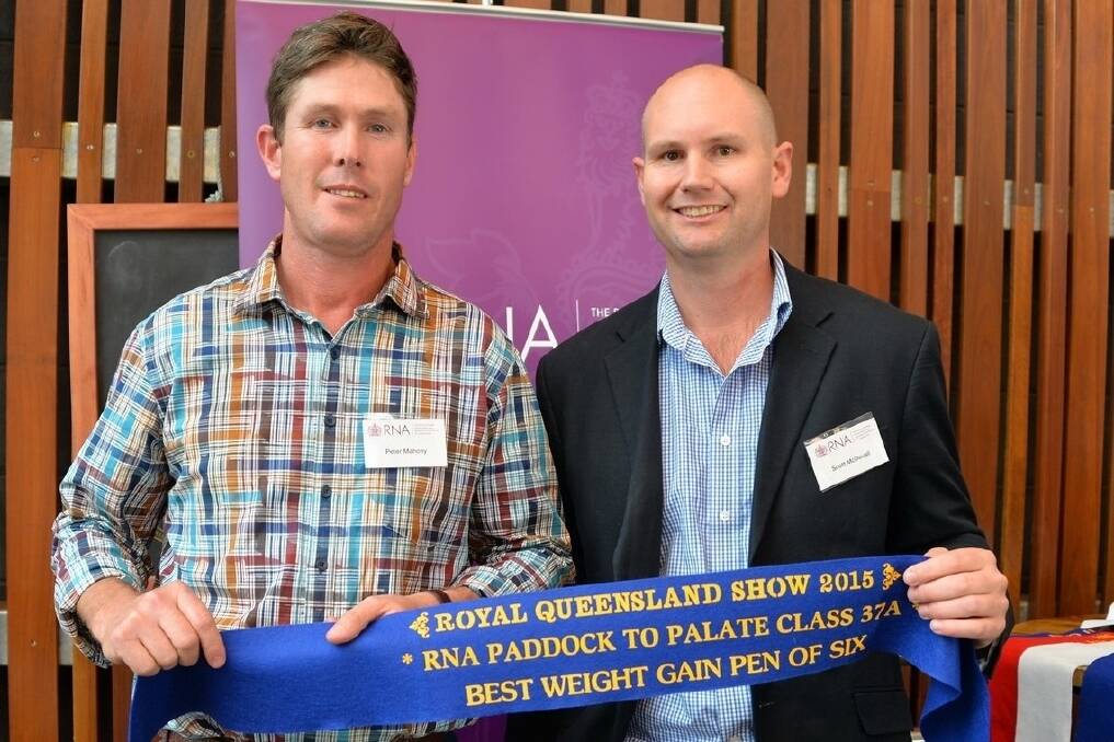 Peter Mahony, Gyranda Santa Gertrudis Stud, Theodore, accepts the class 37 pen of six first place ribbon from Mort and Co general livestock manager Scott McDouall.