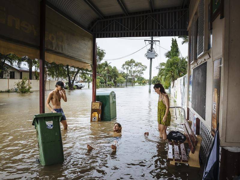 A deluge in and around Townsville has forced residents to flee as flash flooding inundates homes.