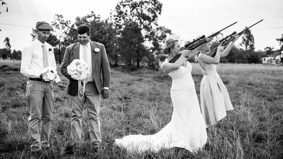 The girls took the guns and the boys the bouquets for this great wedding photo. 