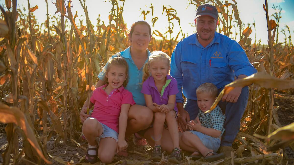 STILL STANDING: Alecia and Ashton McQuade with children Sophie, Holly, and Clay. The corn, while still standing, is rotten in the cob after devastating flooding. 