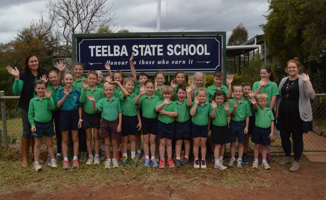 Big grins: Teelba State School principal Karina Schick, her 23 students and P-2 teacher Georgia Ward agree having every second Monday off school makes teaching time more valuable.