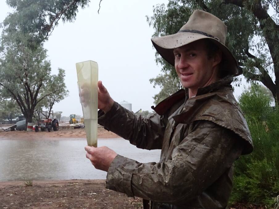 Jesse Moody, Abbadoah, Cunnamulla, braved the elements to check the rain guage again on Tuesday afternoon. Picture: Sally Moody 