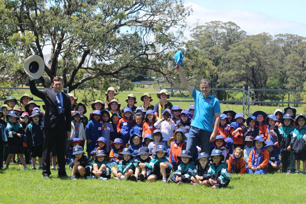 Deputy principal of Downlands College, Toowoomba, Tim Morrison and AgForce CEO, Michael Guerin, with some of the primary school children attending Moo Baa Munch at the school on Tuesday. 