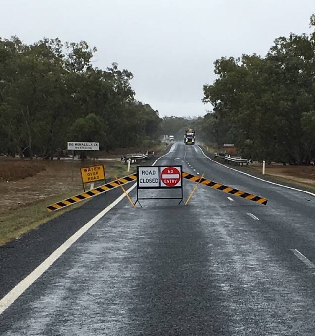 The Department of Transport and Main Roads closed the Warrego Highway 21 kilometres west of Mitchell at the first crossing at Big Womalilla Creek in both directions at about nine o'clock this morning due to flooding. Pictures: Neen Hawkes. 