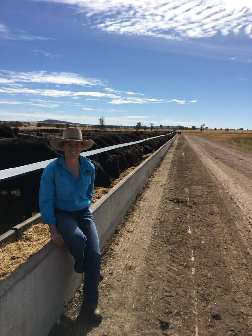 Molly Penfold with a pen of Angus cattle which will be fed for 150 days and then processed under the label Four Daughters Premium Black Angus.
