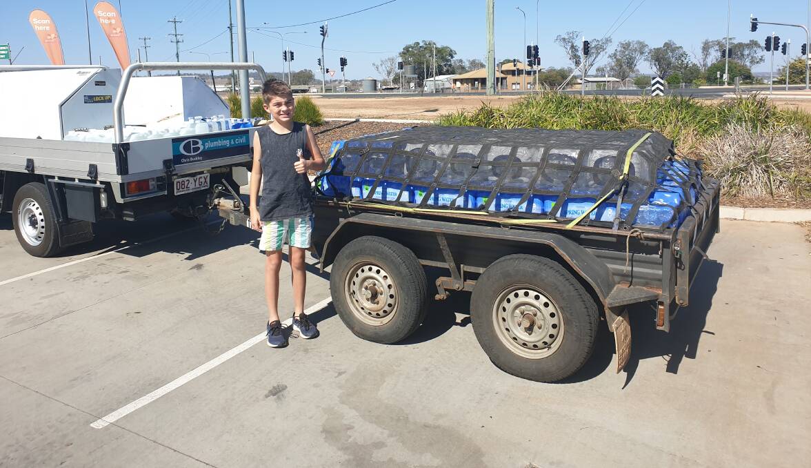William Anderson from Kingsthorpe with three pallets of water he and his parents delivered to the drought stricken Granite Belt. 