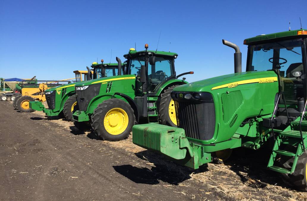 The clearing sale includes three John Deere tractors. 
