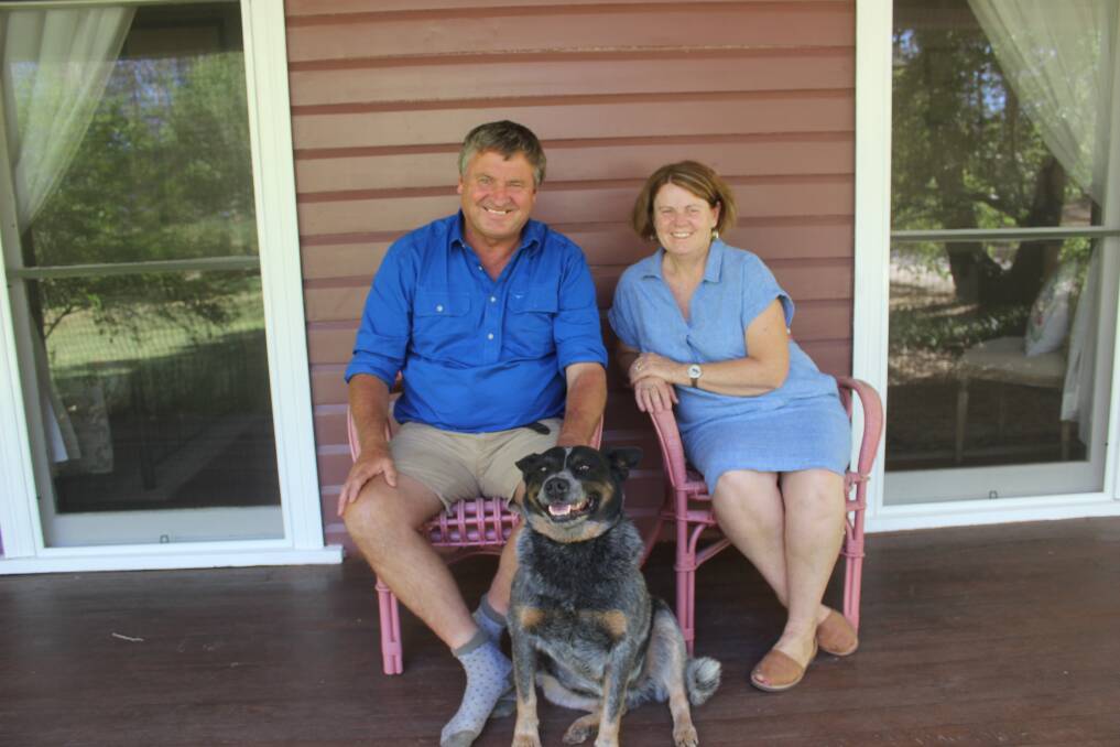 Andrew and Sandra Jenner, with resident pooch Geoffrey, sitting on the verandah that wraps around the home. Picture Helen Walker
