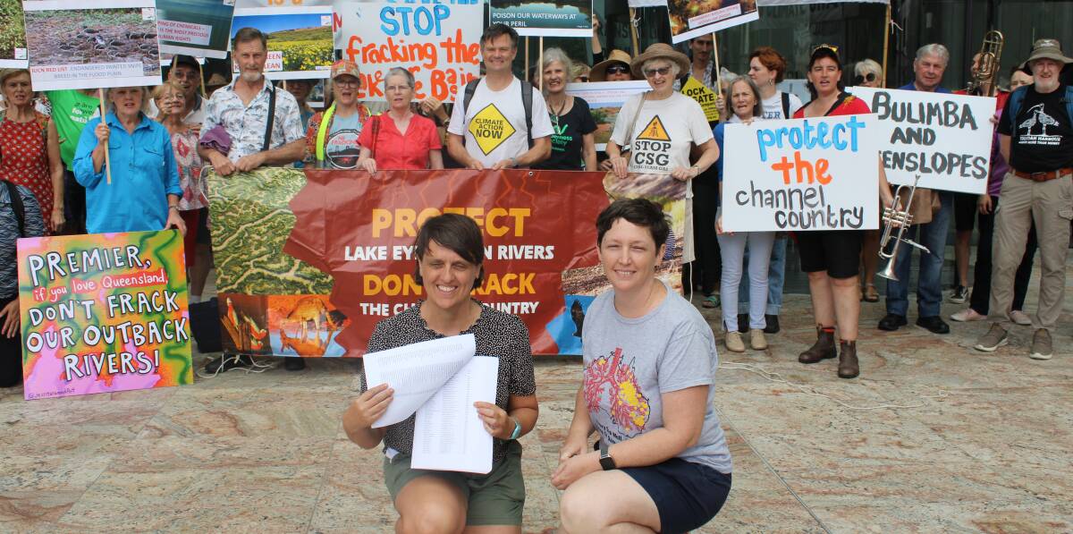 Lock the Gate coordinators Ellie Smith and Ellen Roberts with the petition delivered to the Director-General of the Department of the Premier and Cabinet in William Street. 