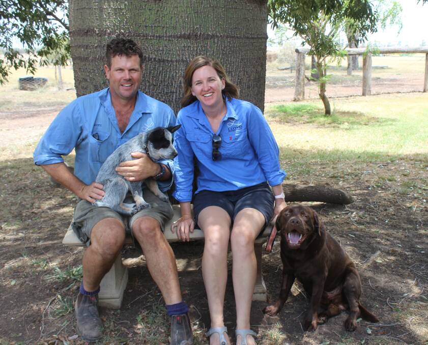 Scott and Katie Lloyd in from of the bottle tree that come to Wieambilla as a sapling, with family pets Ralph and Buddy. 