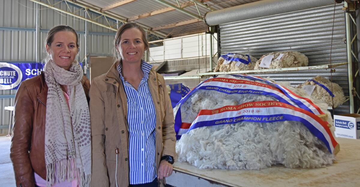 Candice Roberts and Catherine Perrett of Victoria Downs Merino Stud, Morven, with their Grand Champion Fleece at the Roma Show.