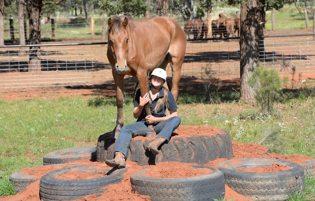 Lauren Hughes, 18, with Lanky after 22 hours of work. She will help her family to train 70 wild horses in seven days during a charity ride.