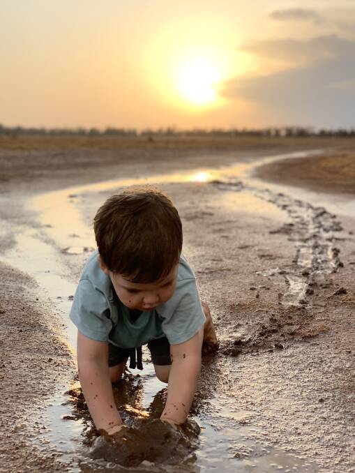 Theo Boshammer, 3, enjoying the 38mm that fell at Elgin, Condamine, last week. The Boshammers recorded a further 4mm in the latest falls, while their neighbours received 21mm. Picture: Kate Boshammer. 