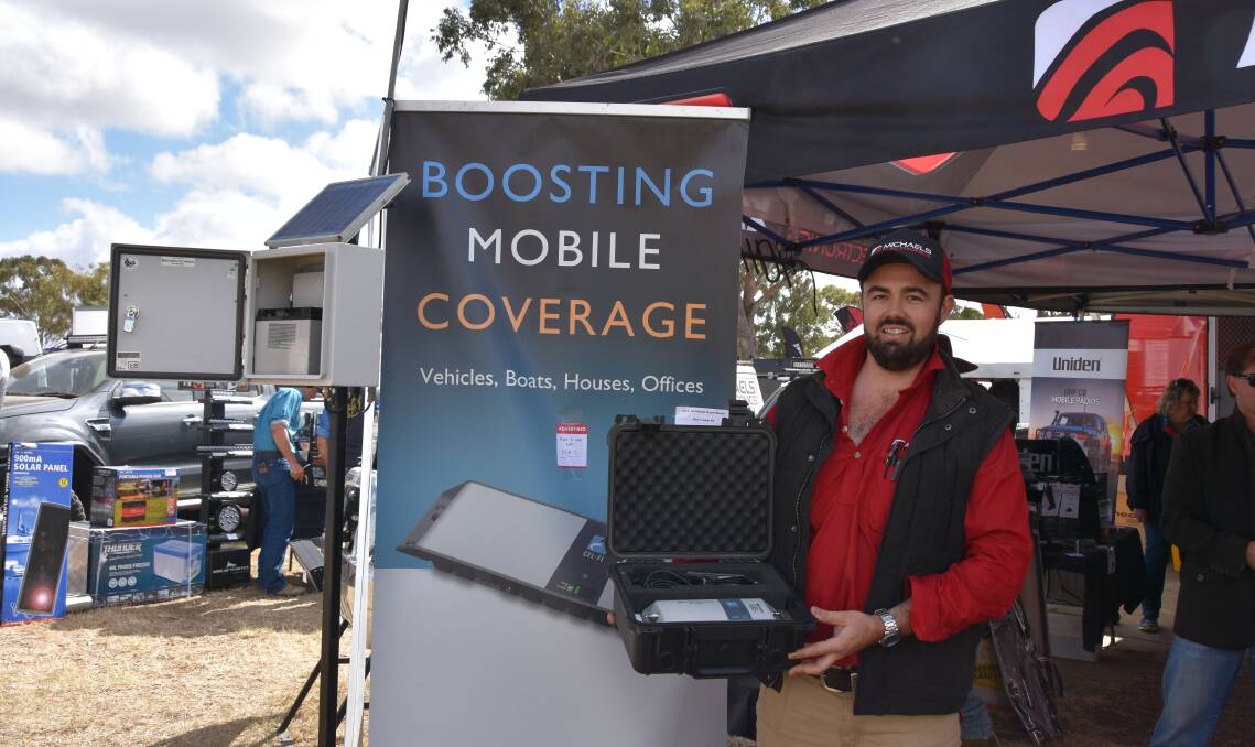 Tim Moran, Michaels Electronics, Toowoomba, at CRT FarmFest 2018 with one of their Cel-Fi car kits. 