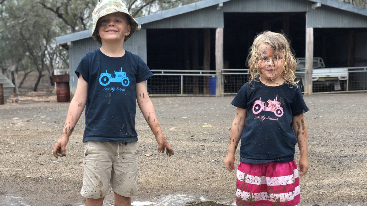 Freddy and Eliza Swayne enjoying the puddles following a shower of rain in Wee Waa - a rare moment in 2019. 