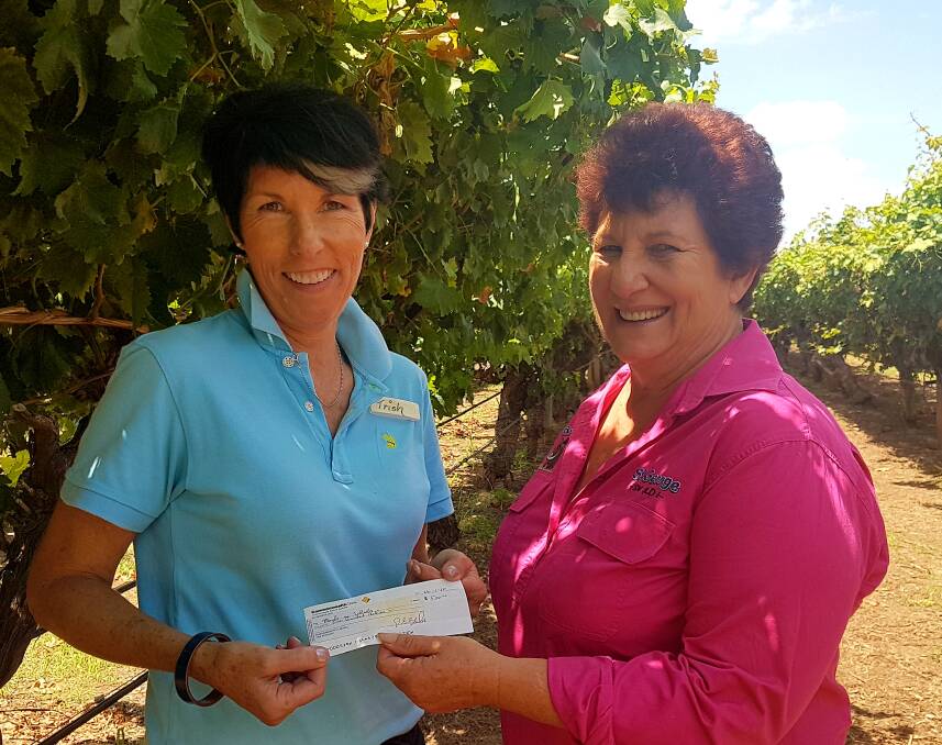Riversands cellar door manager Trish Jensen presenting the proceeds from
the event to Robyn Fuhrmiester on behalf of St George Meals on Wheels to
purchase hot box eskies for deliveries.