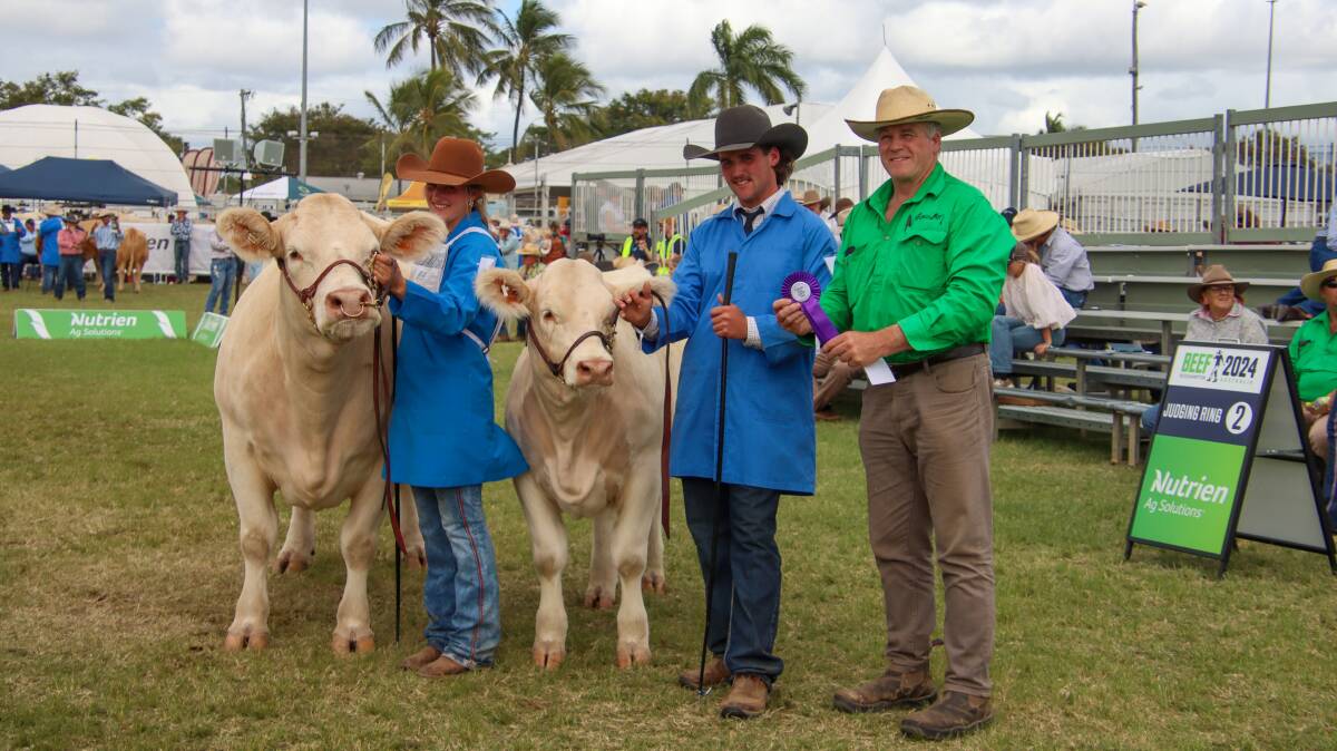 Grand champion female Clearview Raine being held by owner Gabriella Stokes, handler Alexander Stokes and sponsor Roderick Binny from Glenlea Beef. Picture: Melanie Groves