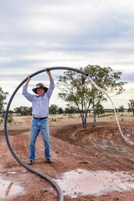 Lee McNicholl on his Wallumbilla property, Forest Grove, on top of his five metre wall where he aims to try and decant gas from his bore pipeline. 