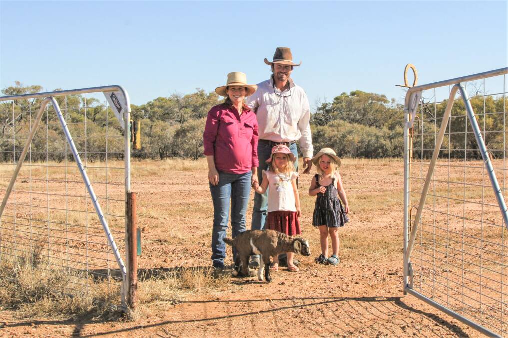 Rob and Sophie Francis and their children Thea and Grace, plus pet goat Spot, at the entrance to their exclusion fenced property, which has opened the gateway to new production opportunities. Photo: Sally Gall
