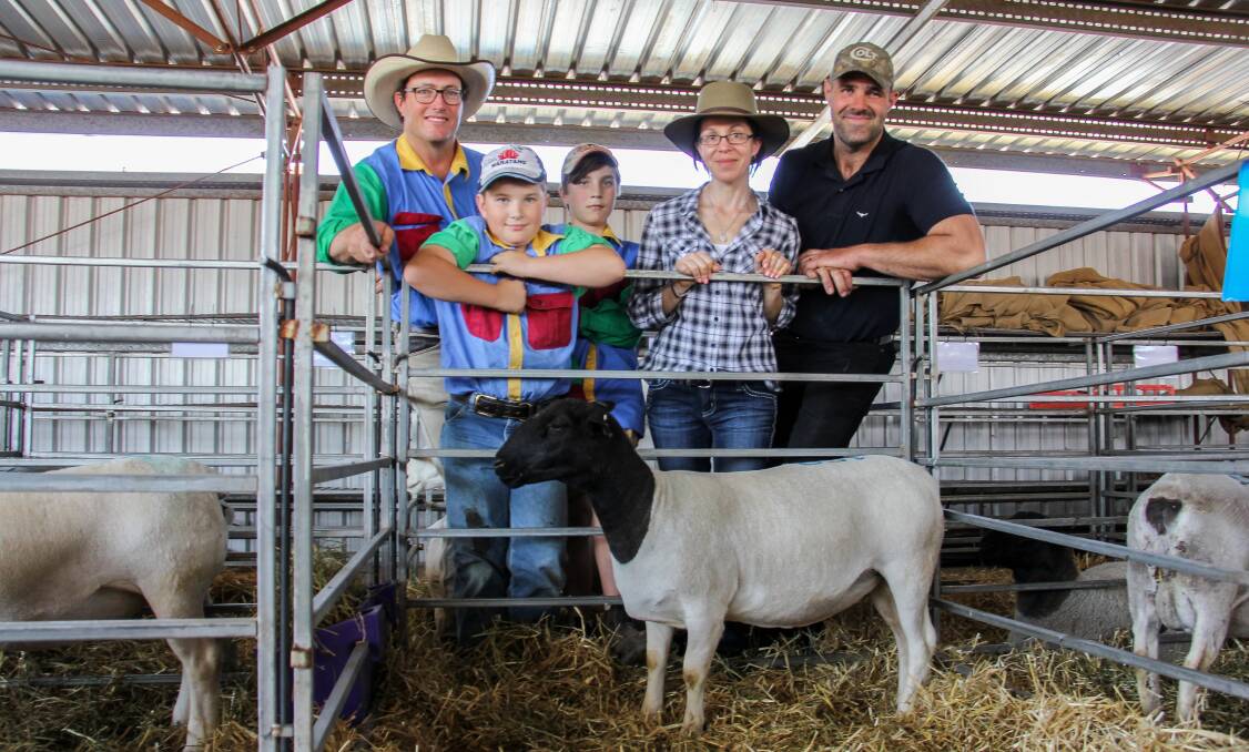 Justin, Flynn and Sam Kirkby, NSW and top price ewe with buyers Rachael and Joe Kopp, Kingaroy. 