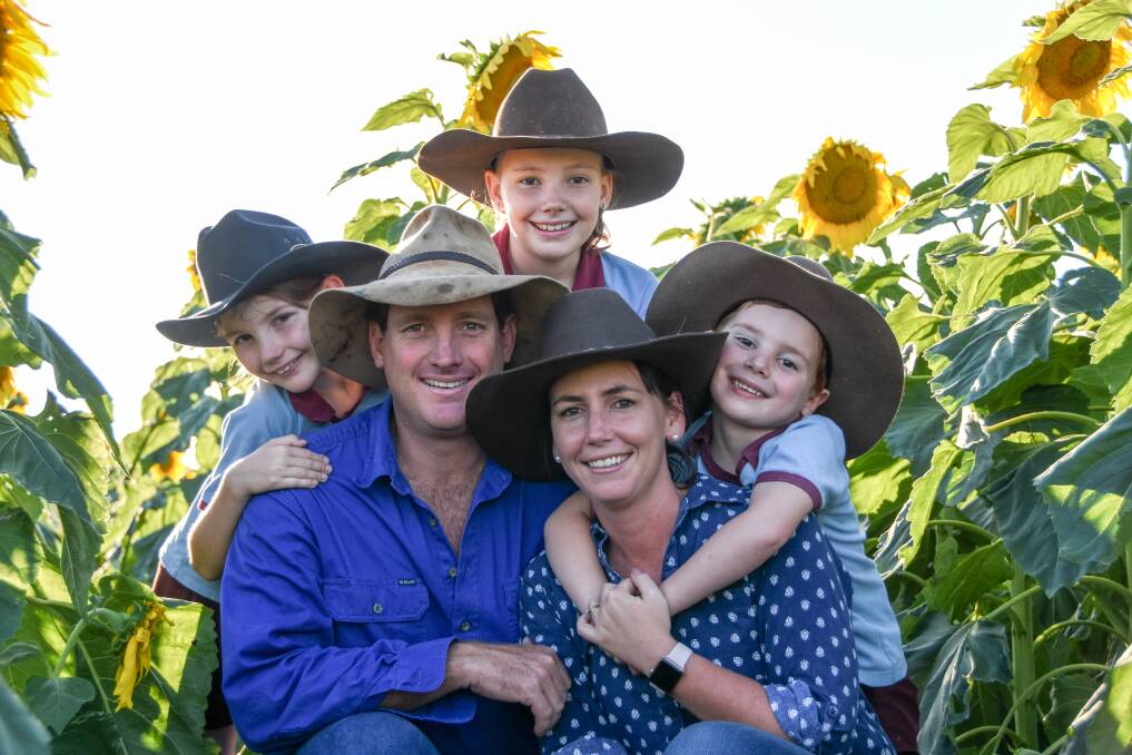 Leah, Claire and Luke McNaughton (back) with their parents Peter and Lauren in their sunflower crop at Coalstoun Lakes. Picture: Lucy Kinbacher