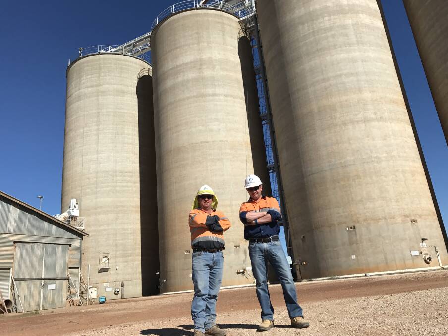 GrainCorp Thallon site manager Darren Kelly and Regional Manager Brad Fosters beside the silos which will be painted. 
 
