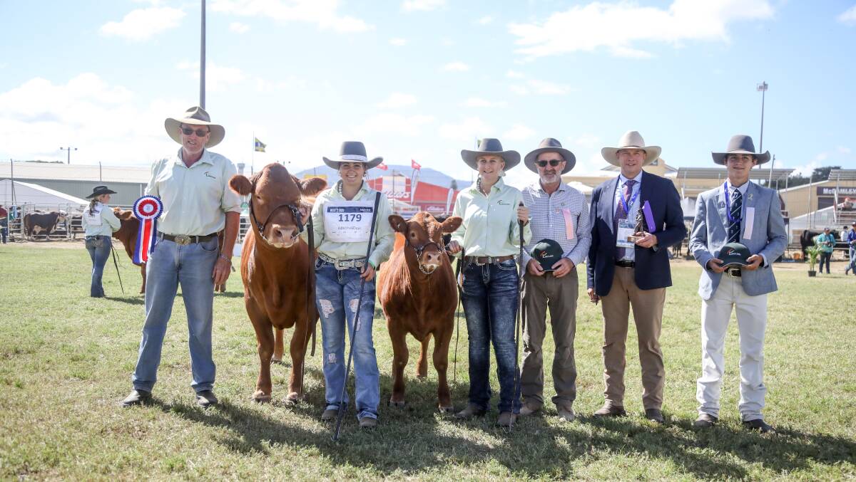 Ray Zahnow and his grand champion cow held by Brooke Parlaine and Shania Gough, with ribbon presenter Chris Meade and judges Berry Reynolds and Hayden Hanson. 