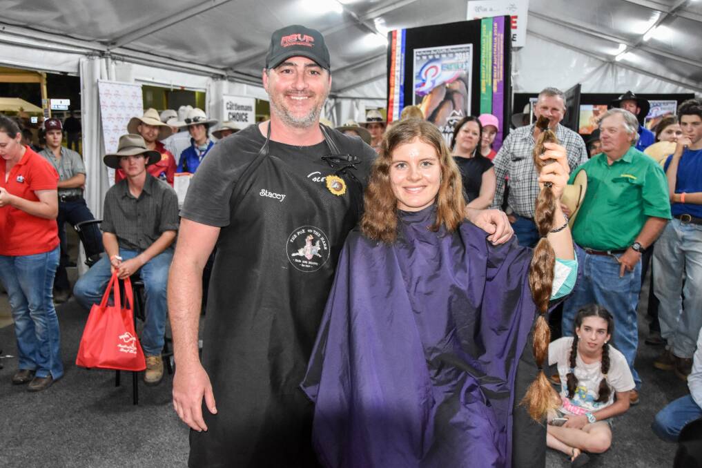 Steven Pickering, RSVP Droughtmasters, paid $380 to chop the hair of Amy Birch, Birch Droughtmasters, Eidsvold, to make wigs for cancer. Picture: Lucy Kinbacher