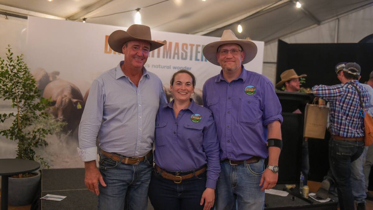 Glenlands D stud principal Darren Childs with Coralyn and Rowan Smith, Smithy's Droughtmasters, Warwick, who bought the in-utero pregnancy offering at the Beef Genetics in Focus Sale on Wednesday night. Picture: Lucy Kinbacher 
