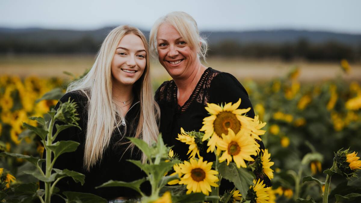 Teely and Eleena Mitchell in their sunflowers. Picture: Susie McLaughlan Photography 