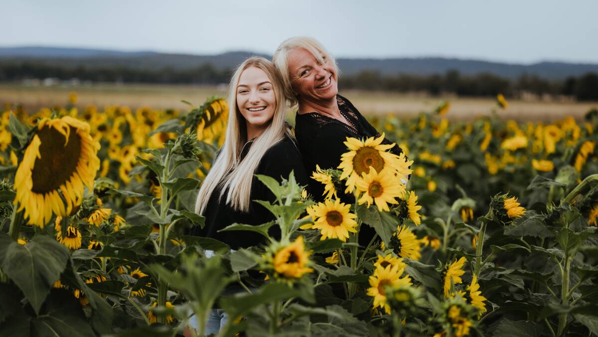 Teely and Eleena Mitchell in their sunflowers. Picture: Susie McLaughlan Photography 