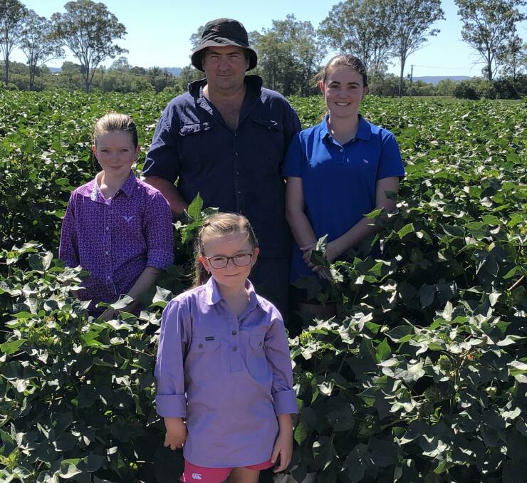 Mark Cowley and his daughters Kelsey, Cassidy, and Michayla in their trial cotton crop at Toogoolawah.