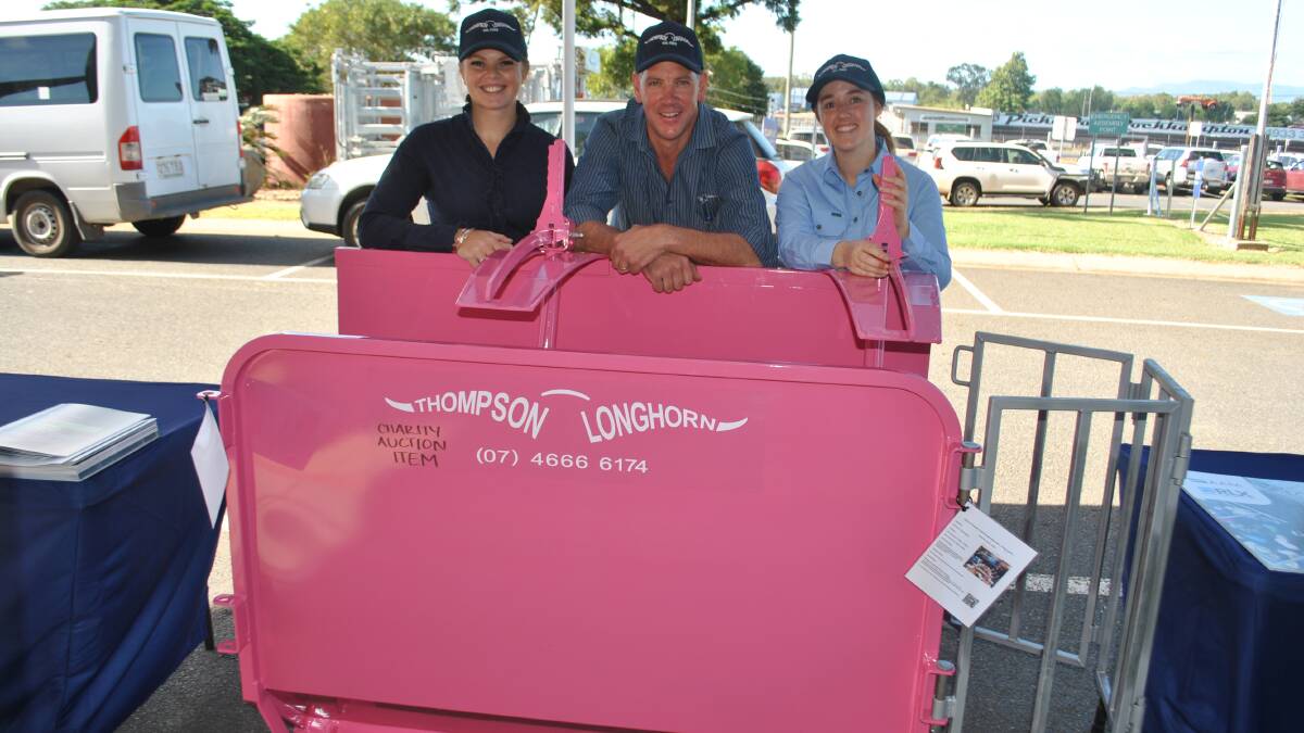 CHARITY AUCTION: Tori Rafton, Byron Wolff and Gina Barnet from Thompson Longhorn with the special pink calf cradle being sold for BreastScreen Queensland.