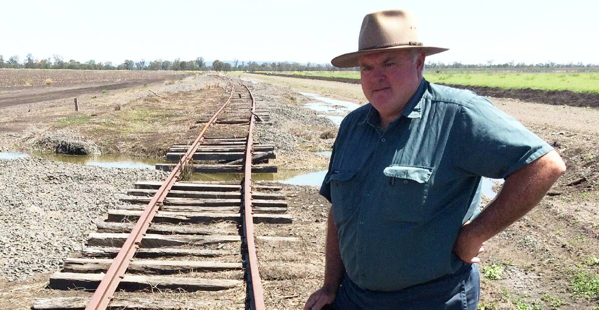 Millmerran Rail Group chairman Wes Judd says he expects the Morrison government will rule out a controversial Inland Rail route crossing the Condamine River floodplain. Mr Judd is pictured with a flood damaged section of the abandoned Millmerran line.