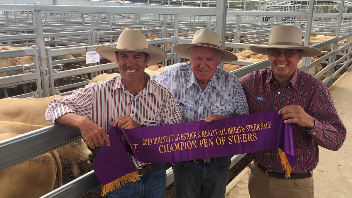 BIGGENDEN: Grand champion pen exhibitors Alan and Neil Goodland from Clare, Theodore, with sponsor Peter Ramsey, Elanco.