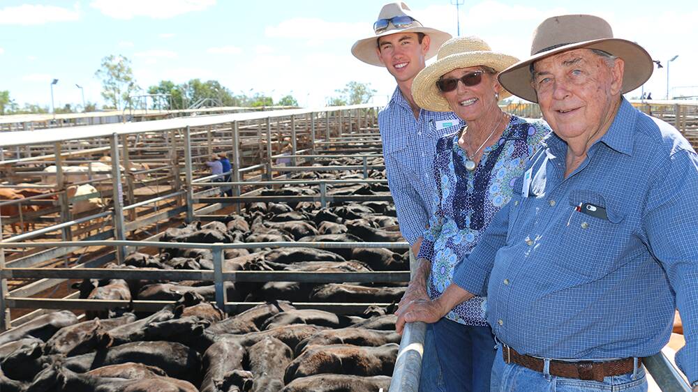 IN THE BLACK: Ian and Joy Macallister with grandson Ben Whip, Roma Downs, Roma, watched 561 of their 271kg Angus cross steers sell for an average of 396c/kg to return $1079/head.