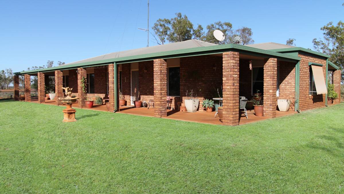 Combanning has a four bedroom brick home set in a maintained garden.